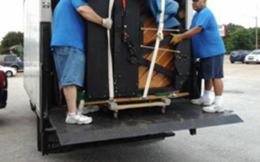 movers unloading a piano
