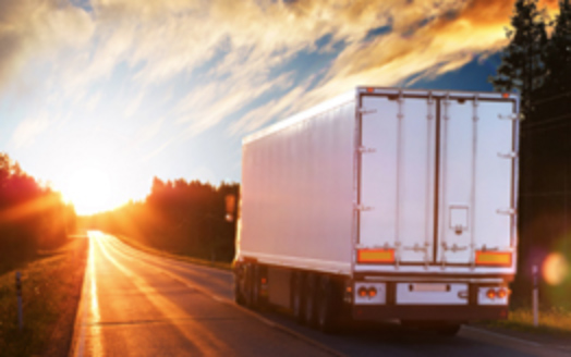 a truck going into a sunset